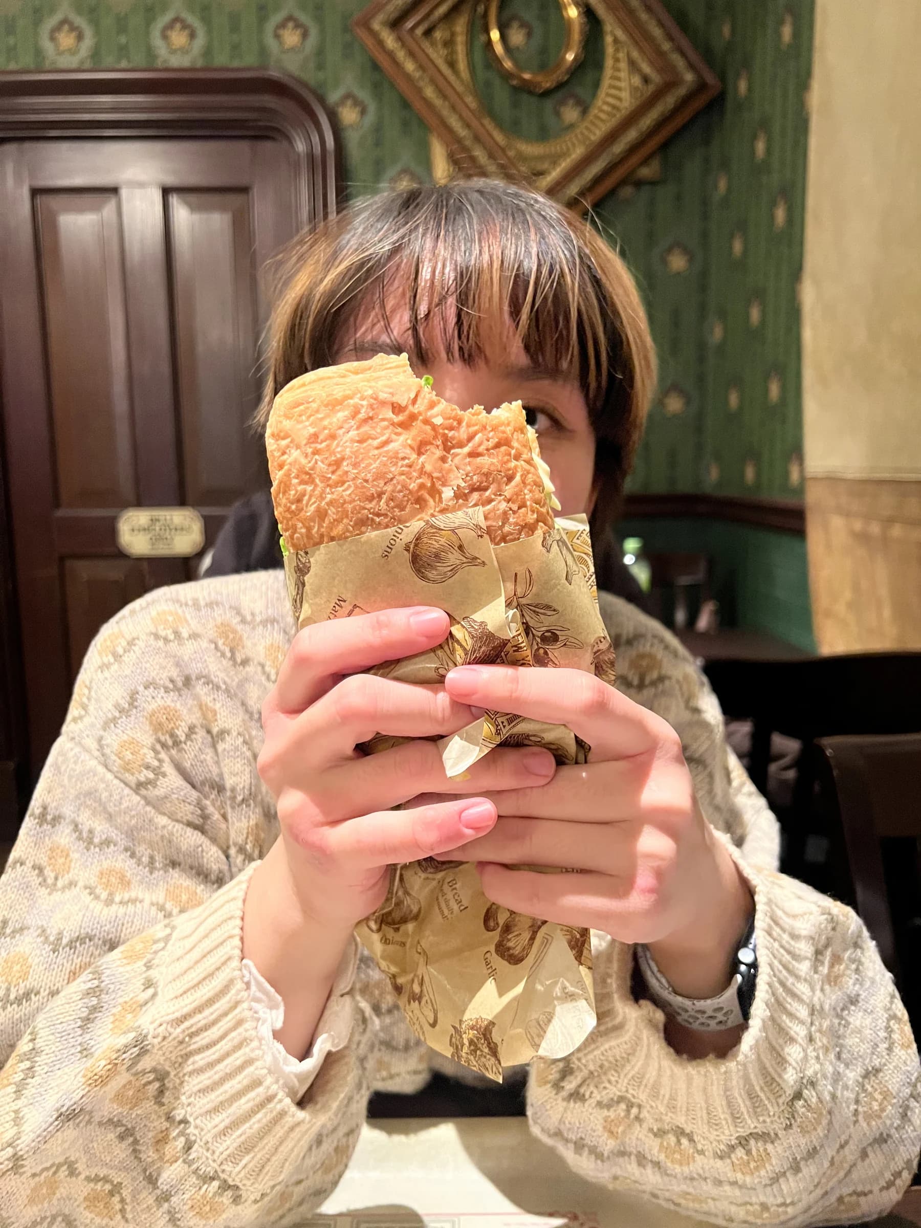 Becky holding a sandwich during her birthday visit to Tokyo DisneySea