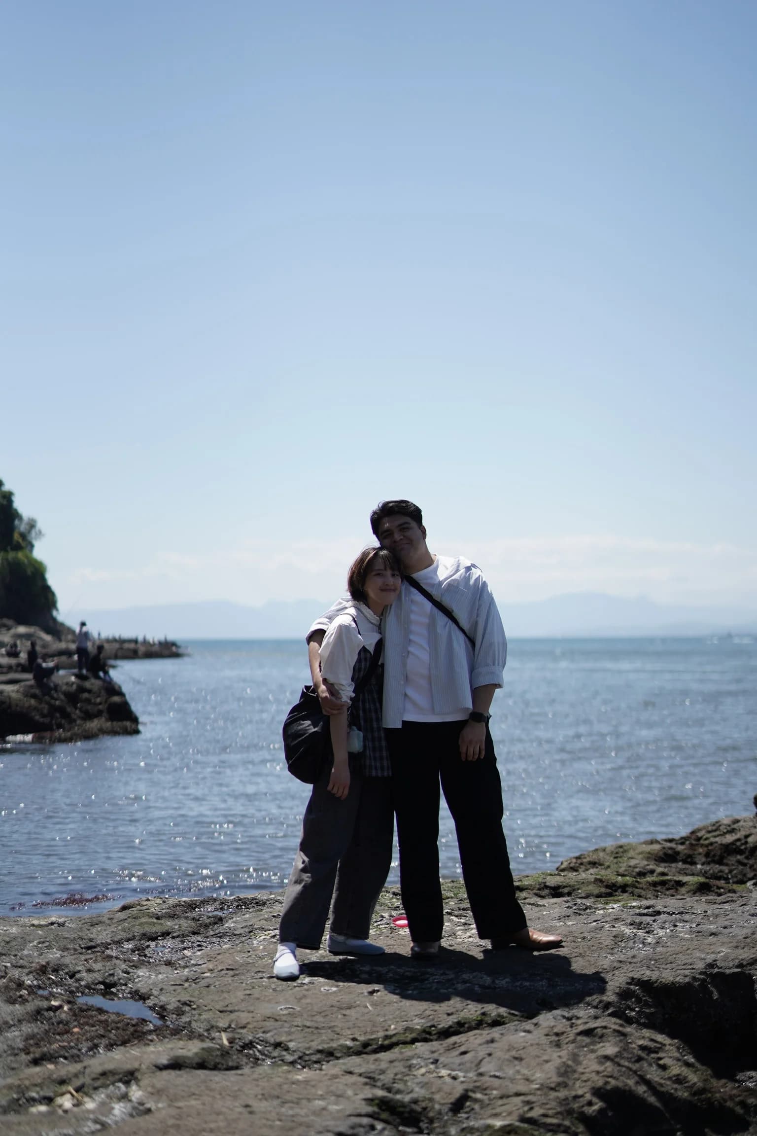 Rebecca and Josue together on the rocky shore in Enoshima